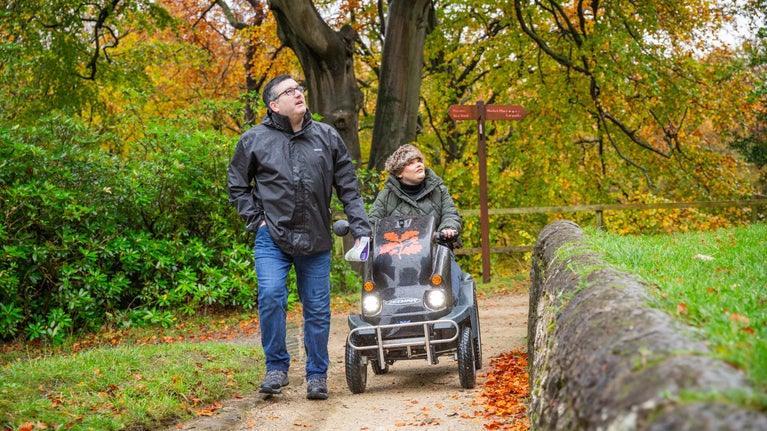 A husband and wife exploring Gibside on a tramper and by foot in autumn